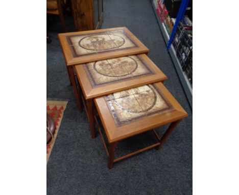 A nest of three mid 20th century Danish teak tile topped tables 