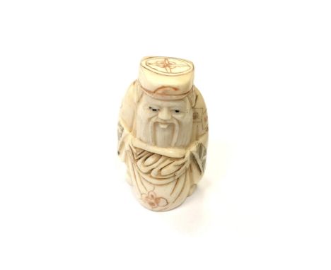 A Japanese carved bone netsuke - Village elder with a sack at his feet. 
