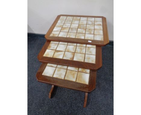 A set of three mid 20th century teak G Plan tile topped tables 