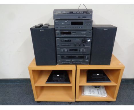 A Sony hifi system with speakers and remote, speaker stands on two contemporary beech stands 
