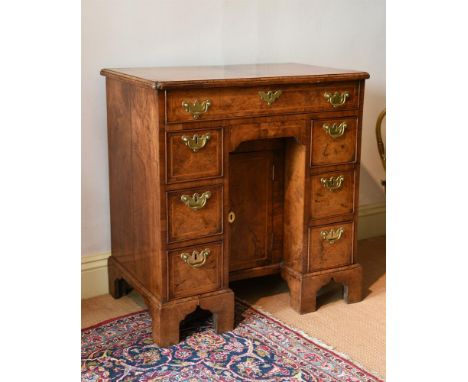 A GEORGE II FIGURED WALNUT AND FEATHER BANDED KNEEHOLE DESK CIRCA 1730 79cm high, 75cm wide, 46cm deep overallProvenance:Barn