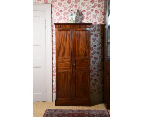 A REGENCY MAHOGANY CUPBOARDCIRCA 1815Of compact proportions, the panel doors opening to a shelved interior182.5cm high, 83cm 