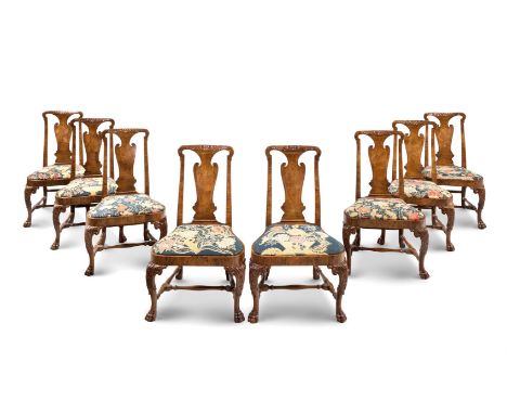 A SET OF EIGHT GEORGE II WALNUT CHAIRS CIRCA 1730each shaped rectangular back with slender foliate carved surround and  surmo