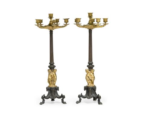 A LARGE PAIR OF PATINATED AND PARCEL GILT SIX LIGHT CANDELABRA 19TH CENTURY Each with floral candle branches above fluted ste