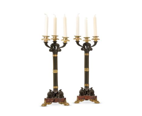 A PAIR OF GILT AND PATINATED CLUSTER COLUMN THREE LIGHT CANDELABRA  19TH CENTURY  Bronzed stems on red serpentine marble base