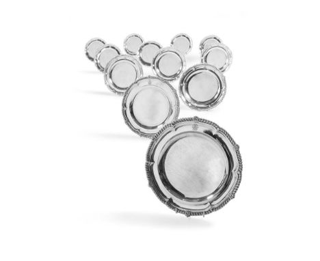 A GEORGE III SET OF TWELVE SILVER SHAPED CIRCULAR PLATESPAUL STORR, LONDON 1813 With gadroon rims, engraved with a crest and 