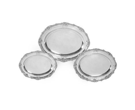 A GEORGE III SET OF THREE SILVER GRADUATED OVAL MEAT PLATESPAUL STORR, LONDON 1811 With gadroon and shell rims, engraved with