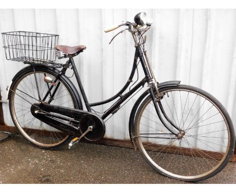 A Sturmey Archer geared vintage ladies bicycle, with a front bicycle lamp, Miller's bike bell and a Brookes brown leather sea