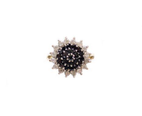 A 9ct gold dress ring, with central layered cluster, set with white and black stones, on two splayed shoulders, ring size M½,