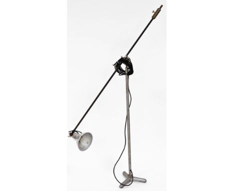 An industrial adjustable floor lamp, on a angle top with shaped shade, on a tripod base, 183cm high.