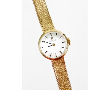 A 9ct gold Tissot ladies cocktail watch, with small silver dial, on a bark effect thin strap, 20cm long overall, the dial 1.5