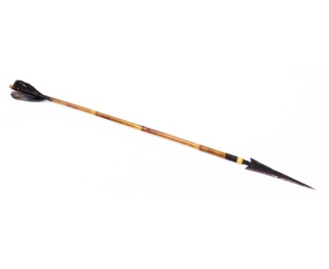 A short arrow, with hammered end, bamboo shaft and feathers, 64cm long. (AF)