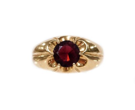 A 9ct gold dress ring, the central oval garnet in claw floral cluster type pierced setting, ring size W, 4.5g all in.