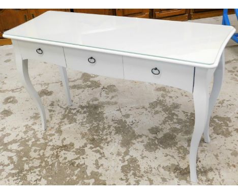 A modern painted console table, the rectangular shaped top with three single drawers with shaped metal handles, on shaped leg