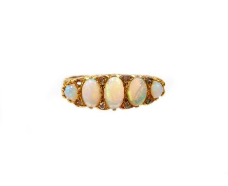 A Victorian 18ct gold opal and diamond gypsy ring, set with five oval opals and eight tiny diamonds, in a scroll design shoul