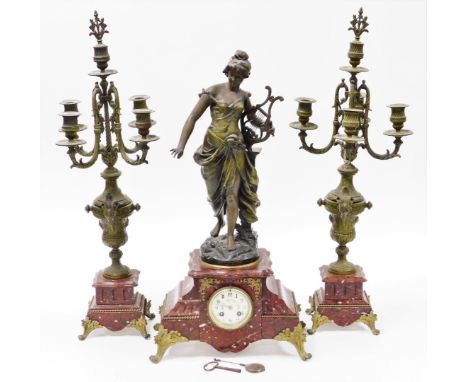 A late 19thC French clock garniture, with mantel clock, on a red marble base with a gilt spleter figure of a maiden with a ha