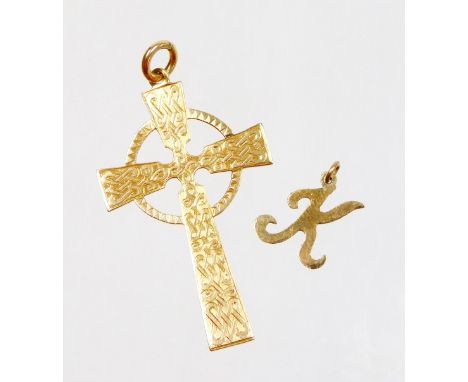 Two pendants, comprising a 9ct gold crucifix pendant, with scroll decoration, 3.1g, and a yellow metal K pendant, unmarked, 0