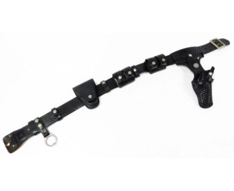 A Wild West type black leather riding belt, with various slide on attachments gun holster, clip, ammunition sections, etc., s