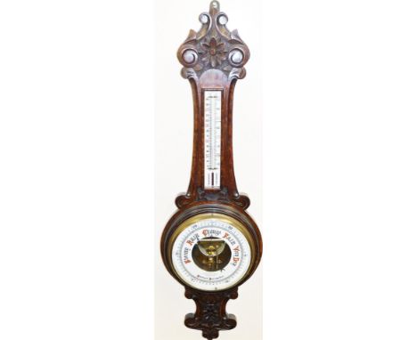A late 19thC mahogany aneroid barometer, with carved flower design, marked Lloyd Paynet and Amiel Manchester, 87cm high.
