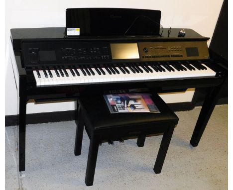 A Yamaha Clavinova CVP-809, in a black high gloss finish, with electronic touch screen panel, on a soft close lid, with Yamah