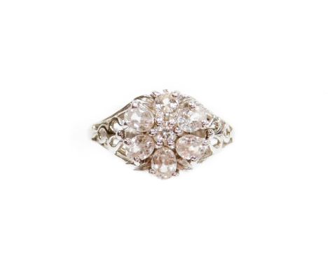 A 9ct white gold diamond dress ring, set in a floral cluster, on pierced design shoulders, ring size N, 3.4g all in, boxed. 