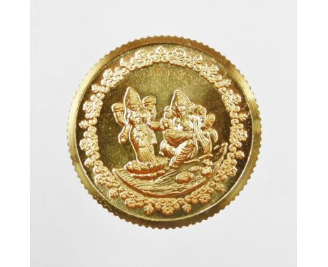 A Tanishq gold coin, depicting two Hindu figures, stamped 995 fine gold, 10g, in presentation sleeve and certificate of authe