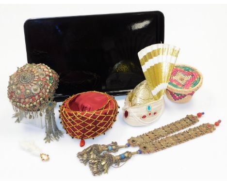 A group of Kailash wedding items, to include a red hat with paste stone drop gold string design set with beads, a cream beade