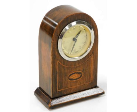 An Edwardian mahogany mantel clock, in a mahogany case with marquetry shell banding with a German wind up clock movement, on 