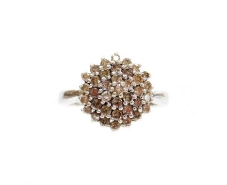 A 9ct white gold diamond dress ring, set in a floral cluster, in a layered decoration, ring size O, 4.3g all in.