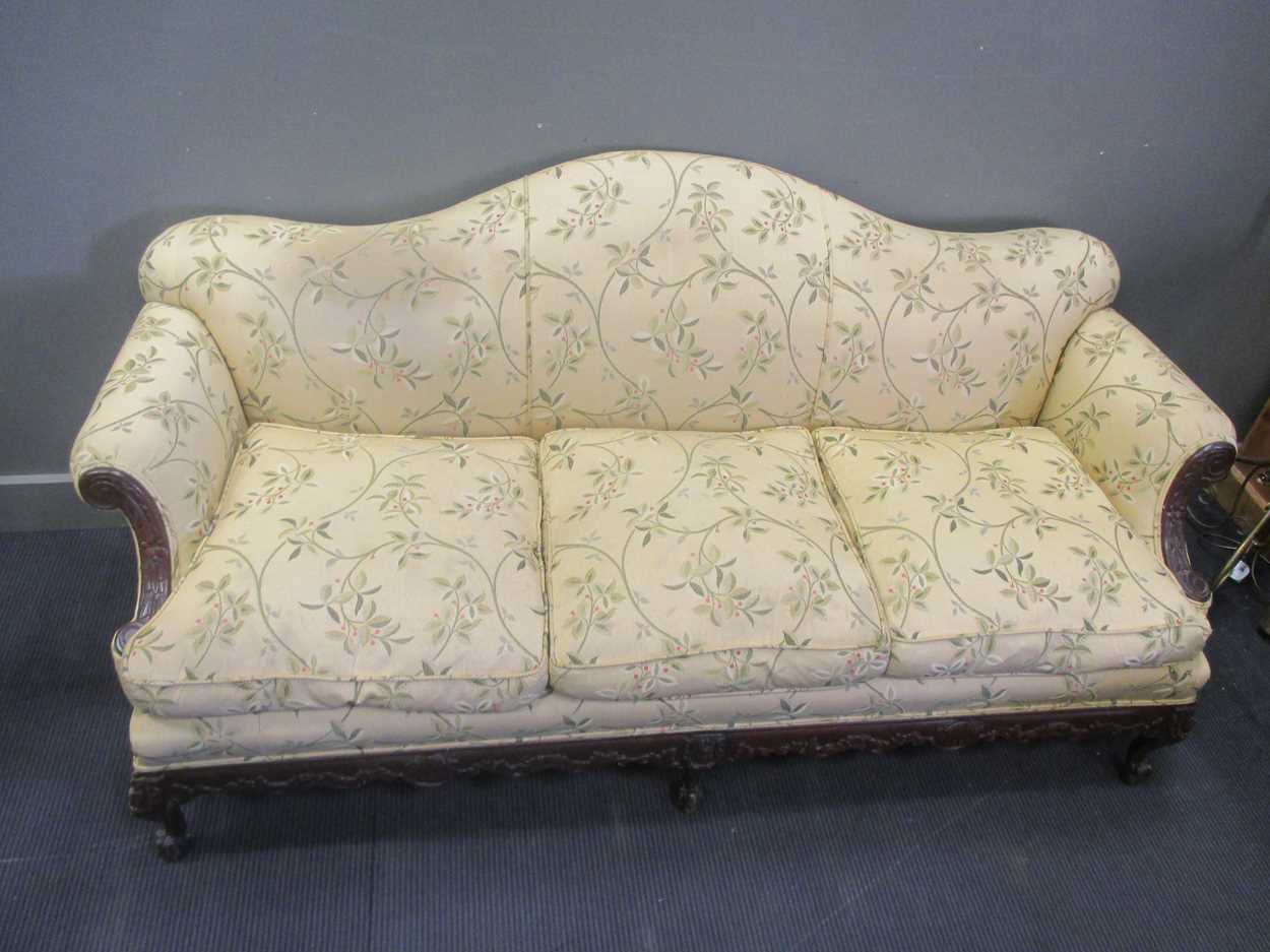 A carved frame camel back sofa, early 20th century, re-upholstered, c ...