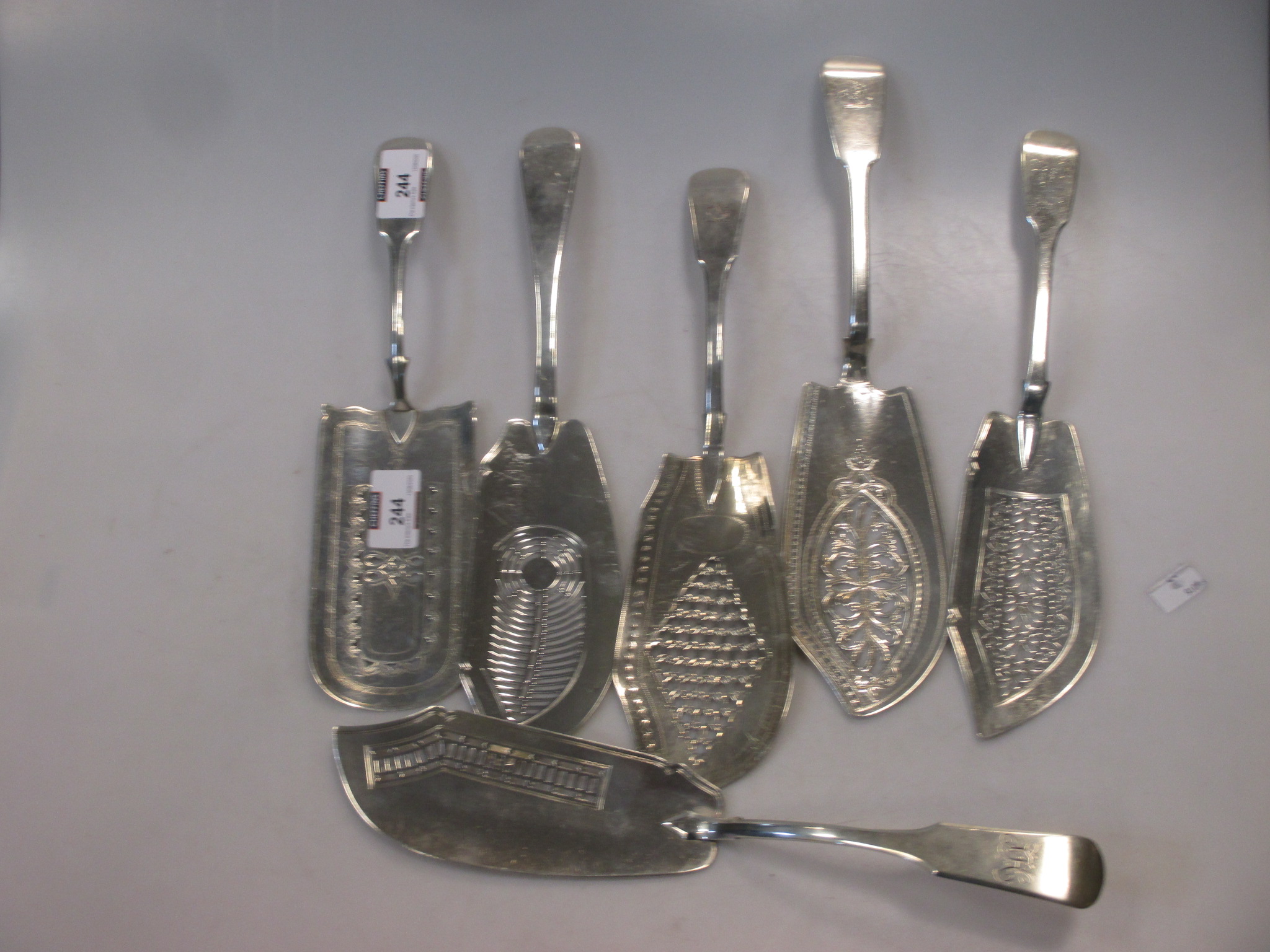 Five III silver fish servers together with a Victorian example 25.8ozt gross (6) in