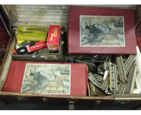 A collection of Marklin and other OO gauge model railway with accessories including buildings and track, all contained within