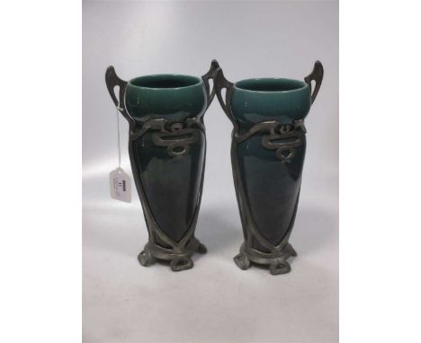 A near pair of Art Nouveau vasesCondition report: 27cm high 14cm wide from one handle to the other Pewter has some wear and s