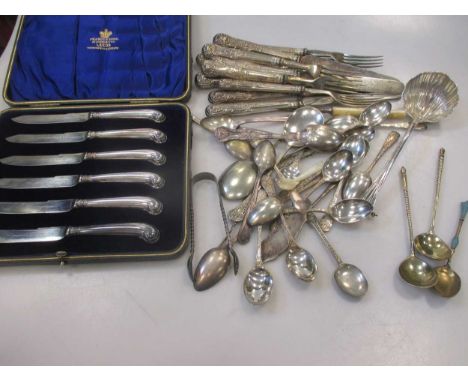 Two Russian silver spoons with gilt bowls, an enamelled spoon, a silver spoon with scroll terminal, and further assorted silv