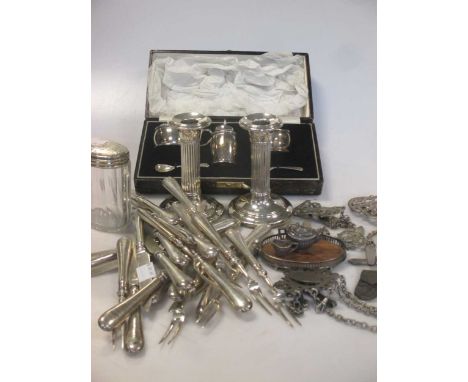 12 pairs of silver bladed and silver handled fruit eaters together with a pair of silver dwarf candlesticks, a cased silver t