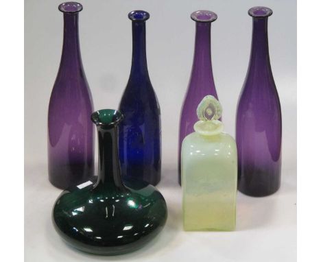 Three amethyst glass carafes, another blue glass example with etched decoration and others