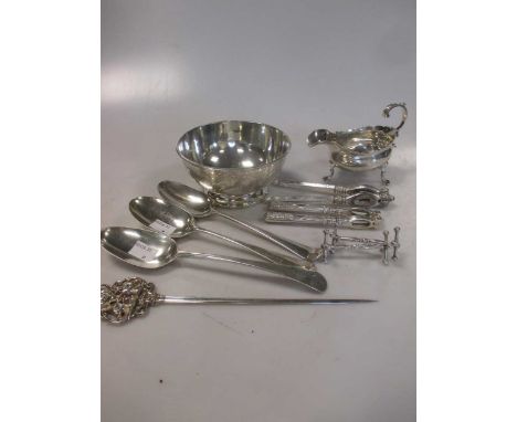 A collection of silverware to include a bowl, a pair of knife rests, three 18th century tablespoons, a sauce boat , a letter 