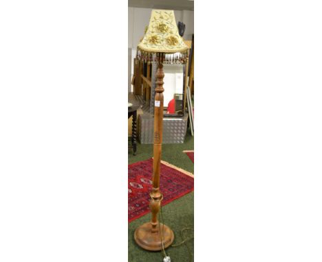 A carved camphor standard lamp with a shade