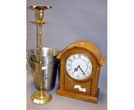 Two stainless steel ice buckets, together with a modern mantle clock and a brass candle stick 