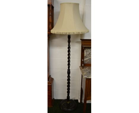 A mahogany twist column standard lamp with shade 