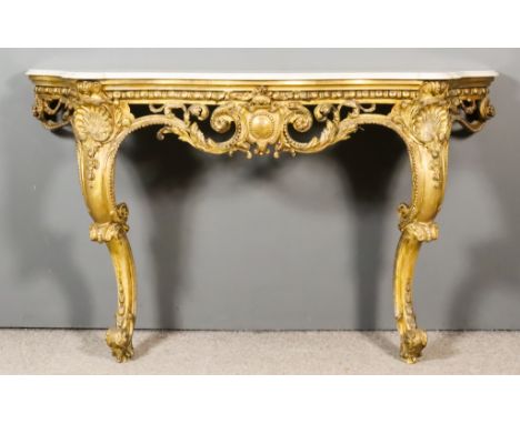 A 19th Century French Gilt Console Table of Bold Shaped Outline, with white marble slab to top with moulded edge, the base of