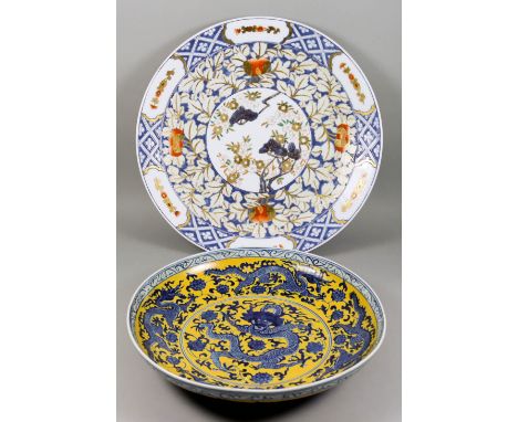  A Chinese Blue, White and Yellow Ground Porcelain Charger, 20th Century, decorated with a five claw dragon chasing the sacre