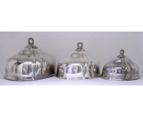 A Set of Three Victorian Plated Graduated Oval Meat Dish Covers, of slightly lobed form, the handles chased and cast with lea