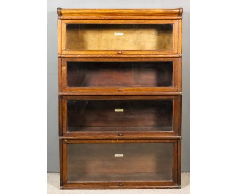 A 1920's Globe Wernicke Oak Four-Tier Sectional Bookcase, with glazed rising fronts, 34ins wide x 12ins deep x 51ins high, (l