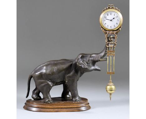 A Late 19th /Early 20th Century Continental Gilt Brass and Bronzed Spelter "Mystery" Clock, the timepiece with 1.75ins diamet