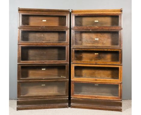 A Pair of 1920's Globe Wernicke Oak Five Tier Sectional Bookcases, with glazed rising fronts and shaped plinth bases, 34ins w