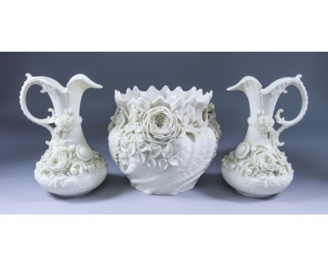 A Pair of Belleek Porcelain Ewers, 2nd Mark, 1891-1926, modelled with floral sprays, 9.25ins high, and a jardiniere modelled 