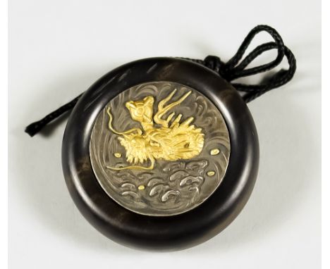 A Japanese Kagmibuta Netsuke, Meiji Period, the ebony bowl 45mm diameter, the dark shibuichi plate inlaid with a gold dragon 