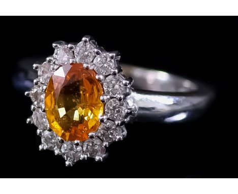 A Yellow Sapphire and Diamond Ring, Modern, in 18ct white gold mount, the centre set with a yellow sapphire, approximate weig