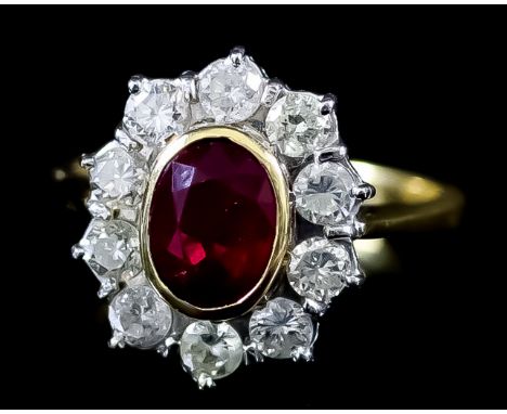 A Ruby and Diamond Ring, Modern, in 18ct yellow gold mount, the centre set with a ruby, approximate weight 1ct, surrounded by